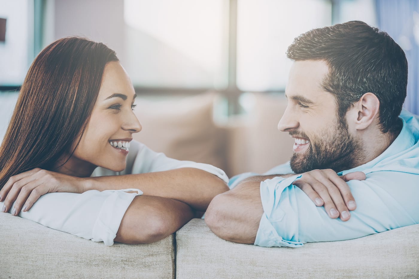 Racial Couple Joy Sitting Face to Face